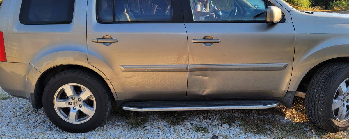 Repair or replace the dented door panel