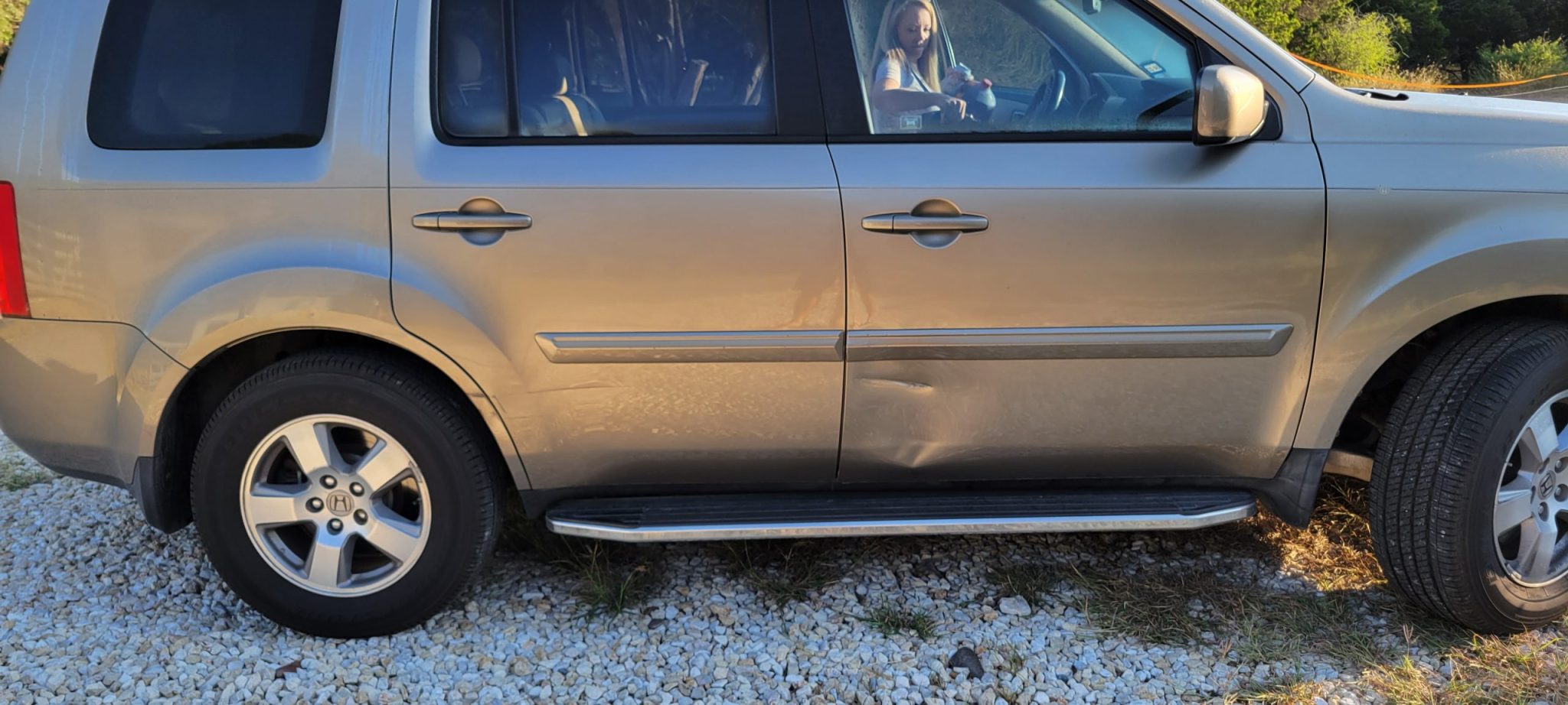 Repair or replace the dented door panel